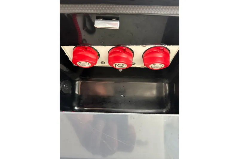 Slide: The Image of Red battery switches on a 2021 ShearWater 270 Carolina Flare boat. - 23