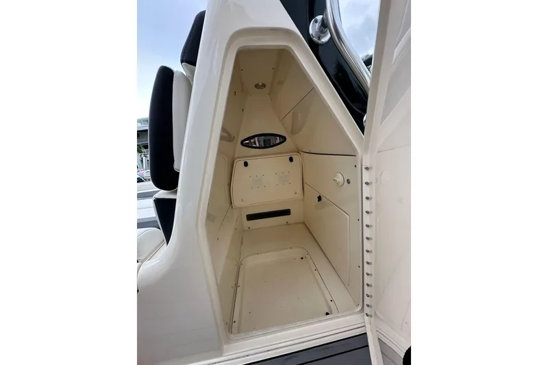 Slide: The Image of 2021 ShearWater 270 Carolina Flare interior cabin with storage space and seating. - 24