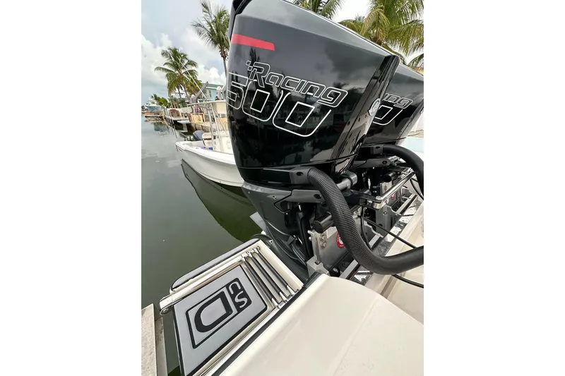 Slide: The Image of 2021 ShearWater 270 Carolina Flare boat with powerful racing engines docked by palm trees. - 25