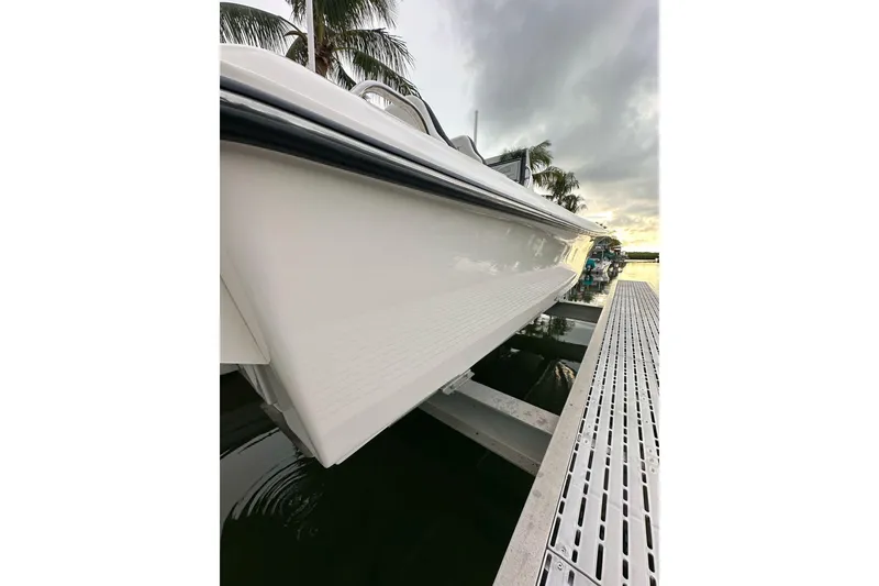 Slide: The Image of 2021 ShearWater 270 Carolina Flare boat docked, side view with palm trees and sunset. - 26