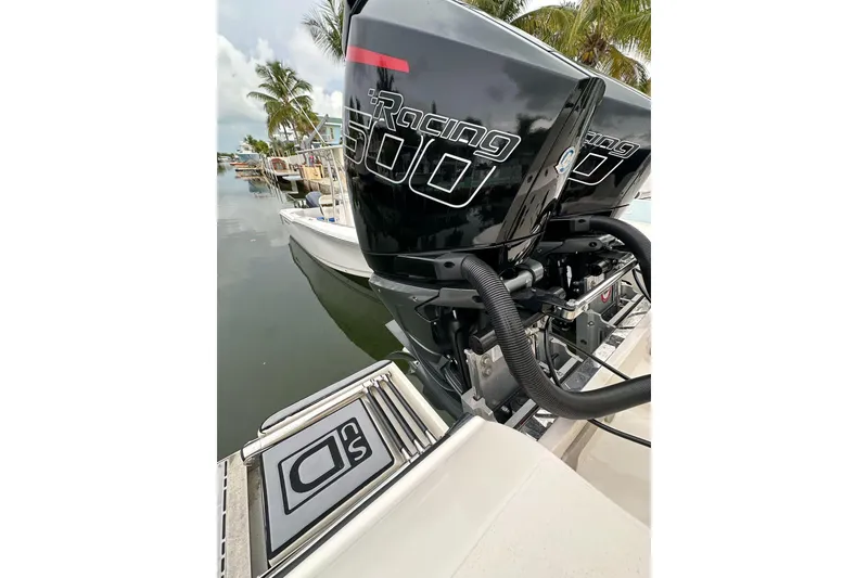 Slide: The Image of 2021 ShearWater 270 Carolina Flare with powerful Racing 500 engines docked by palm trees. - 29