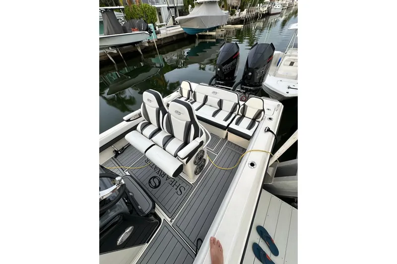 Slide: The Image of 2021 ShearWater 270 Carolina Flare boat with dual engines, docked in a marina. - 3