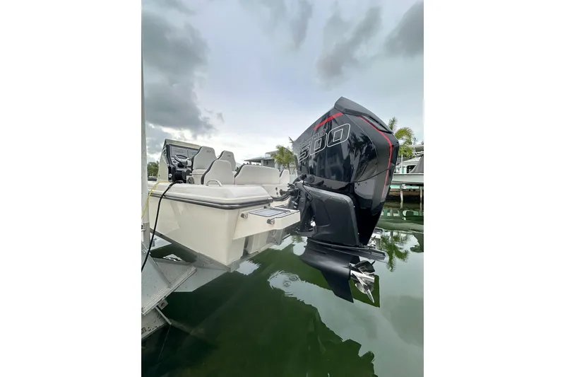 Slide: The Image of 2021 ShearWater 270 Carolina Flare boat with powerful outboard motor on calm water. - 35