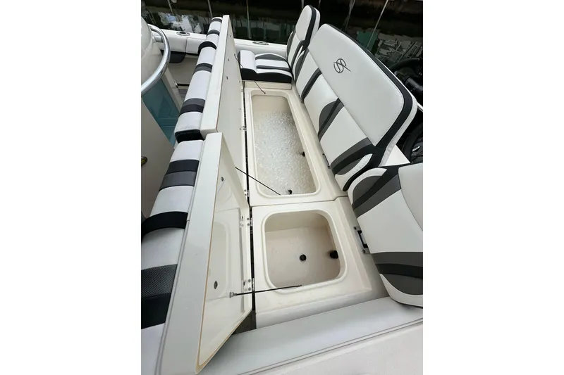 Slide: The Image of 2021 ShearWater 270 Carolina Flare boat with open storage compartments and cushioned seating. - 37