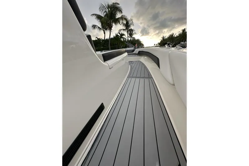 Slide: The Image of 2021 ShearWater 270 Carolina Flare boat deck with sleek design and palm trees in background. - 43