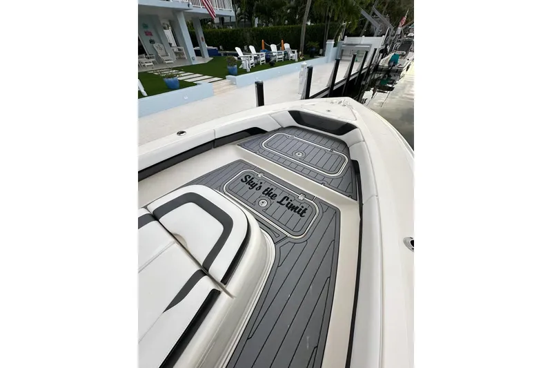 Slide: The Image of 2021 ShearWater 270 Carolina Flare boat with custom deck, docked near a modern house. - 44