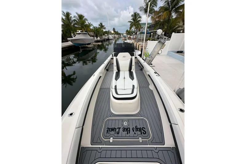 Slide: The Image of 2021 ShearWater 270 Carolina Flare boat docked by palm trees. - 46