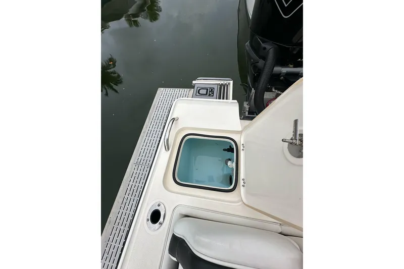 Slide: The Image of 2021 ShearWater 270 Carolina Flare boat with open hatch and visible engine. - 48