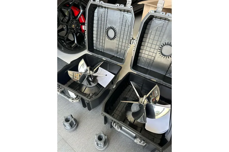 Slide: The Image of Propellers in cases for 2021 ShearWater 270 Carolina Flare boat, with car wheel in background. - 49