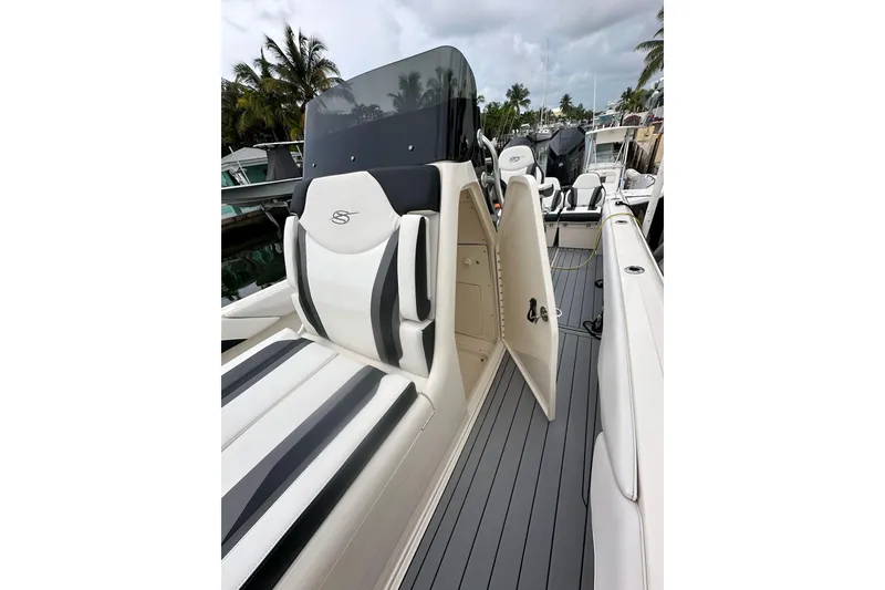Slide: The Image of 2021 ShearWater 270 Carolina Flare boat interior with sleek seating and open storage compartment. - 5