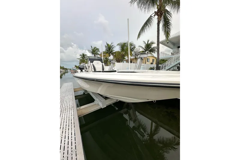 Slide: The Image of 2021 ShearWater 270 Carolina Flare boat docked near palm trees. - 7