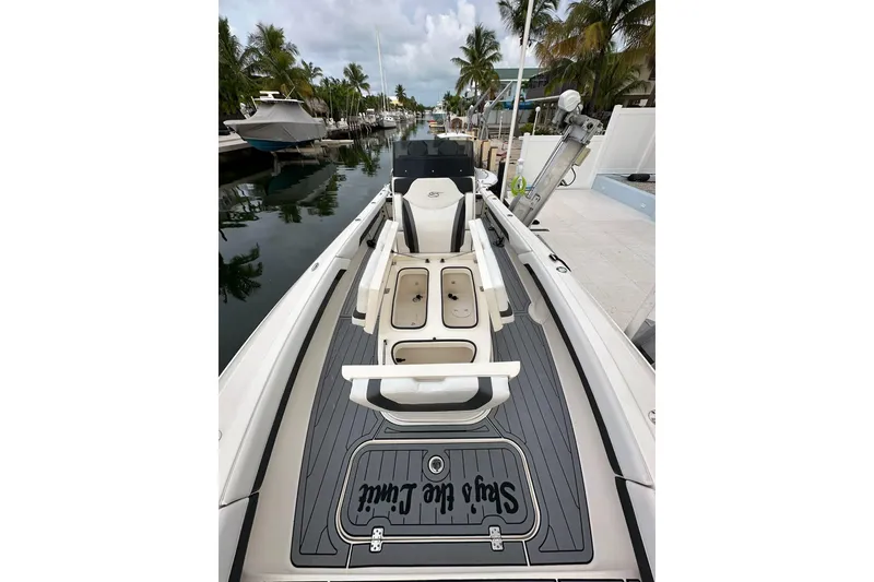 Slide: The Image of 2021 ShearWater 270 Carolina Flare boat docked, featuring sleek design and spacious deck. - 9