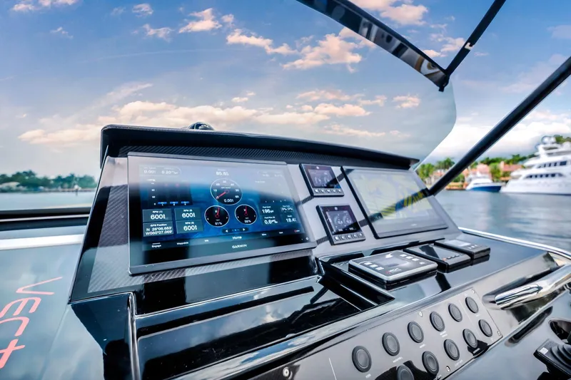 Slide: The Image of Helm of 2021 Pardo Yachts 38 with advanced navigation displays, docked by the water. - 23