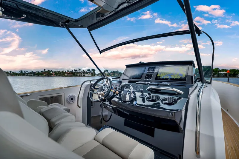 Slide: The Image of Luxurious 2021 Pardo Yachts 38 cockpit with modern controls and scenic water view. - 25