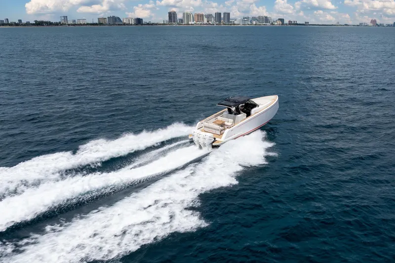 Slide: The Image of 2021 Pardo Yachts 38 cruising on open water with city skyline in background. - 46