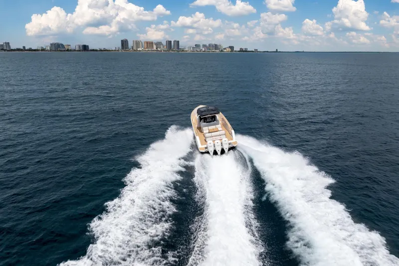 Slide: The Image of 2021 Pardo Yachts 38 cruising on open water with city skyline in background. - 49
