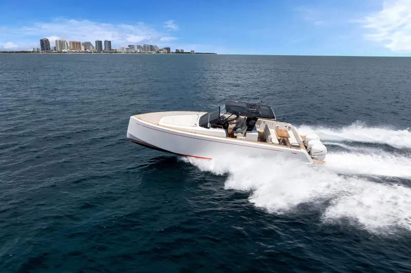 Slide: The Image of 2021 Pardo Yachts 38 cruising on open water with city skyline in background. - 56