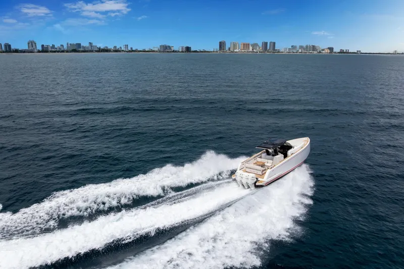 Slide: The Image of 2021 Pardo Yachts 38 cruising on open water with city skyline in background. - 58