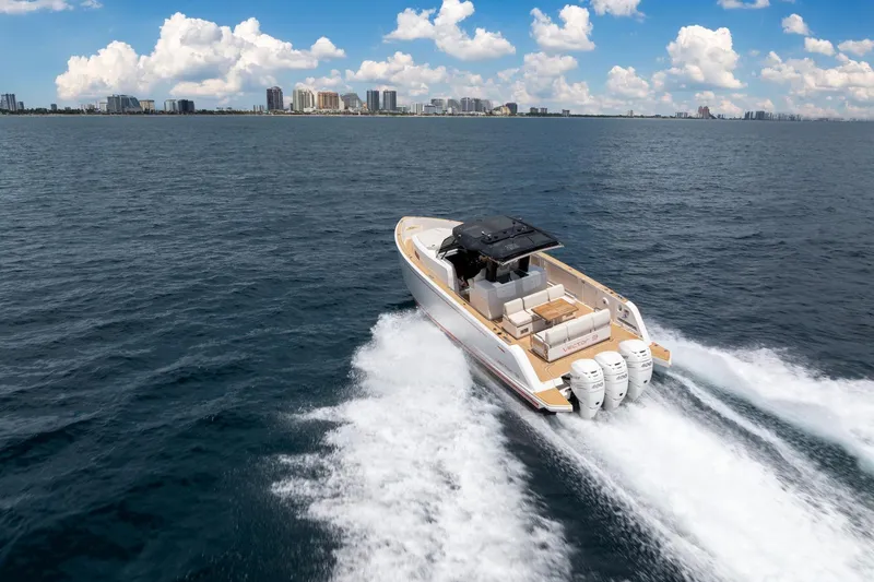 Slide: The Image of 2021 Pardo Yachts 38 cruising on open water with city skyline in background. - 60