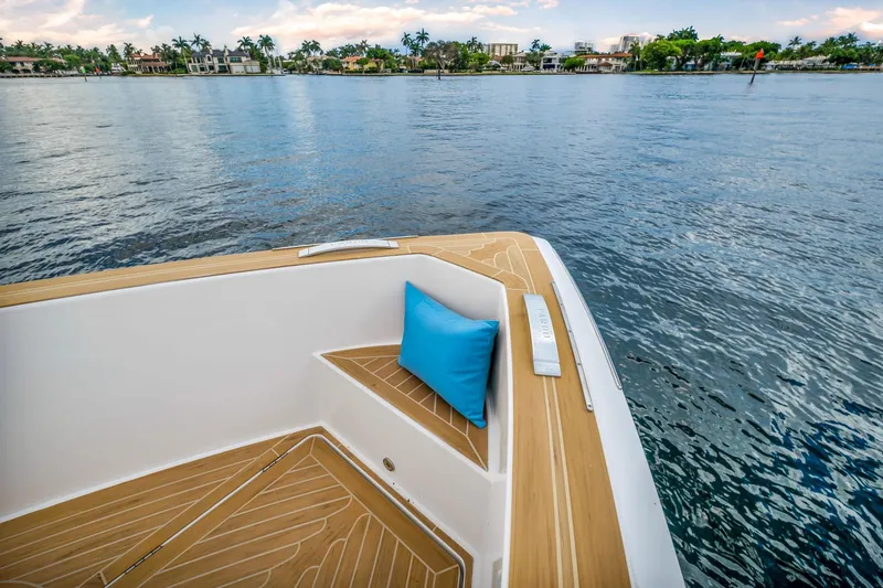 Slide: The Image of Pardo Yachts 38 (2021) deck with blue cushion, overlooking serene waterfront. - 7