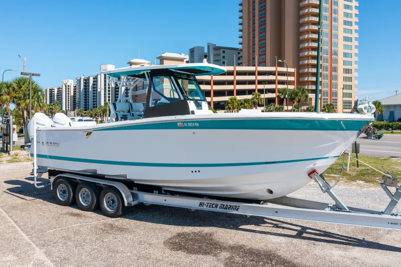 The Image of 2023 Blackfin 302 CC boat on trailer, urban background, clear sky. - 0