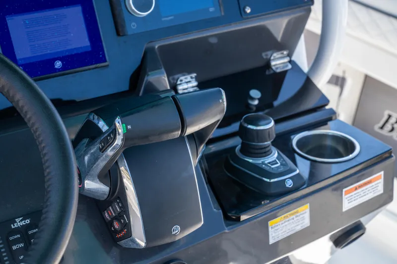 Slide: The Image of 2023 Blackfin 302 CC boat dashboard with controls and steering wheel. - 18