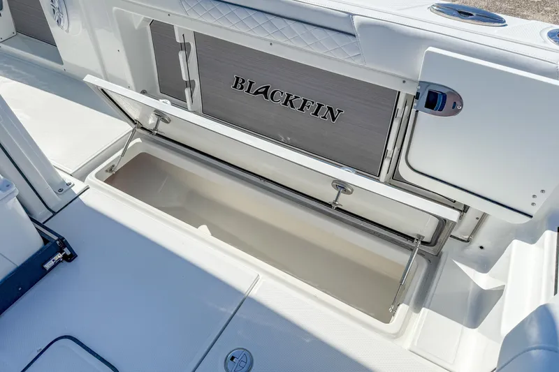 Slide: The Image of 2023 Blackfin 302 CC boat storage compartment open, showcasing spacious interior. - 21