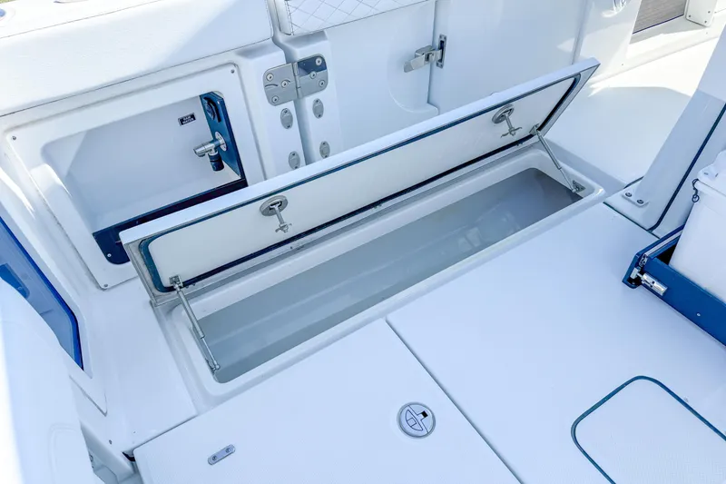 Slide: The Image of 2023 Blackfin 302 CC boat storage compartment with open hatch, showcasing interior space. - 22