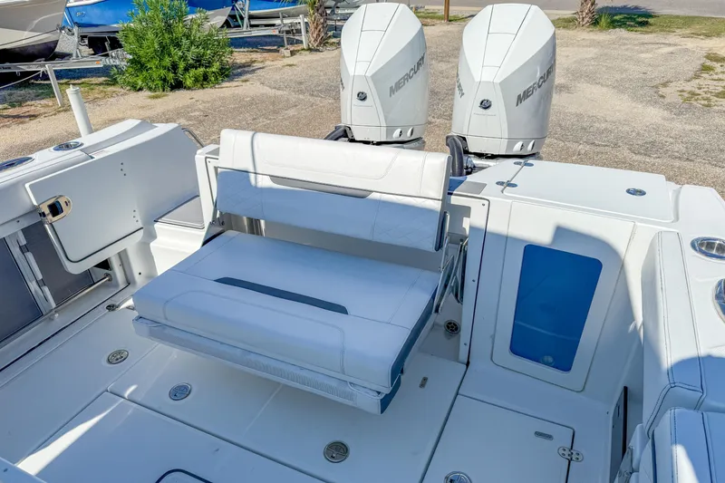 Slide: The Image of 2023 Blackfin 302 CC boat with dual Mercury engines and spacious seating area. - 25