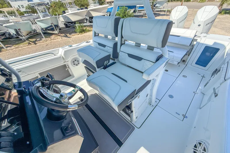 Slide: The Image of 2023 Blackfin 302 CC boat interior with dual helm seats and steering wheel. - 27