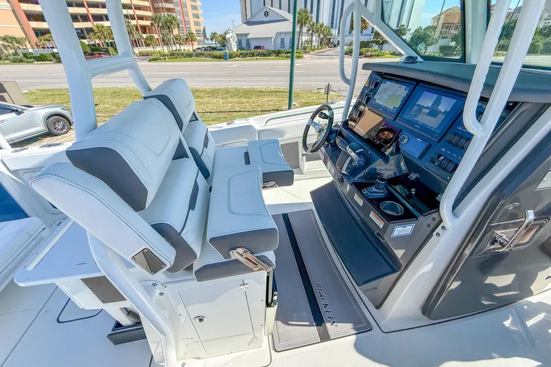 Slide: The Image of 2023 Blackfin 302 CC boat cockpit with modern controls and seating. - 29