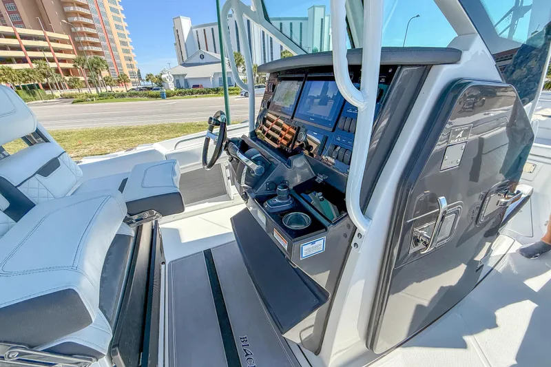 Slide: The Image of 2023 Blackfin 302 CC boat cockpit with advanced navigation controls and seating. - 30