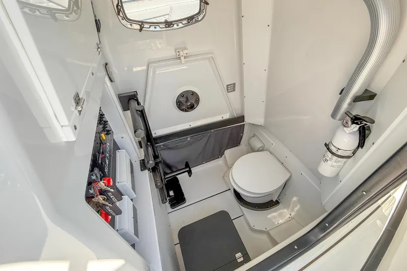Slide: The Image of 2023 Blackfin 302 CC boat interior with toilet, storage, and safety equipment. - 32