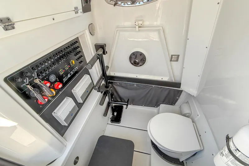Slide: The Image of 2023 Blackfin 302 CC boat interior with control panel and marine toilet. - 33