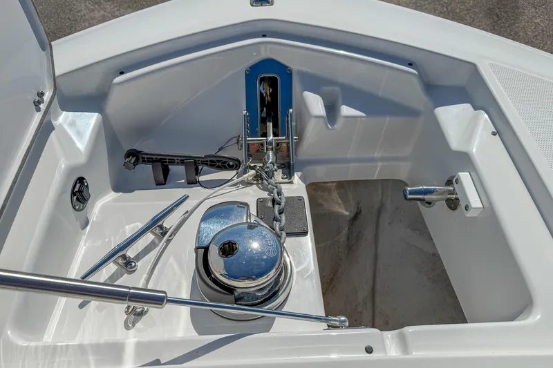 Slide: The Image of 2023 Blackfin 302 CC boat anchor compartment with polished metal fittings and rope. - 39
