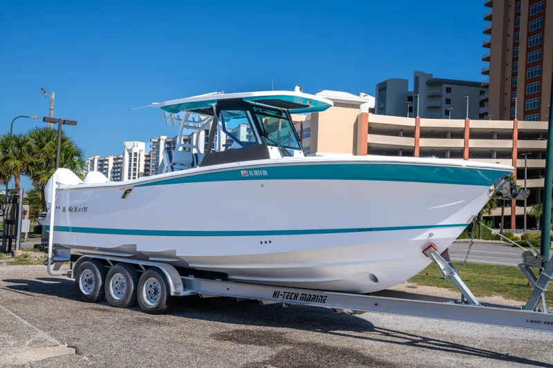 Slide: The Image of 2023 Blackfin 302 CC boat on trailer, urban background, clear blue sky. - 4