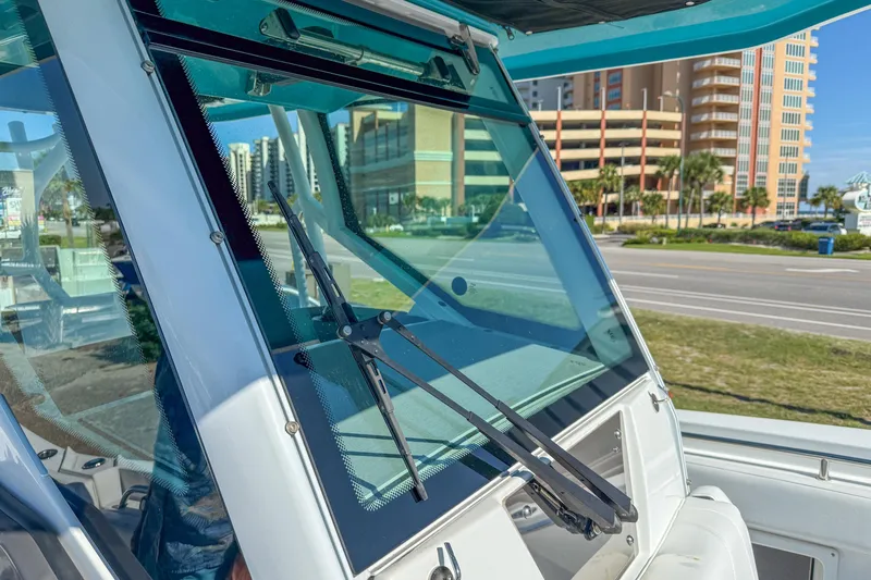 Slide: The Image of 2023 Blackfin 302 CC boat windshield with wipers, cityscape in background. - 51