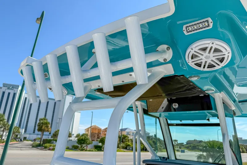 Slide: The Image of 2023 Blackfin 302 CC boat with rod holders and speakers, showcasing modern design. - 52