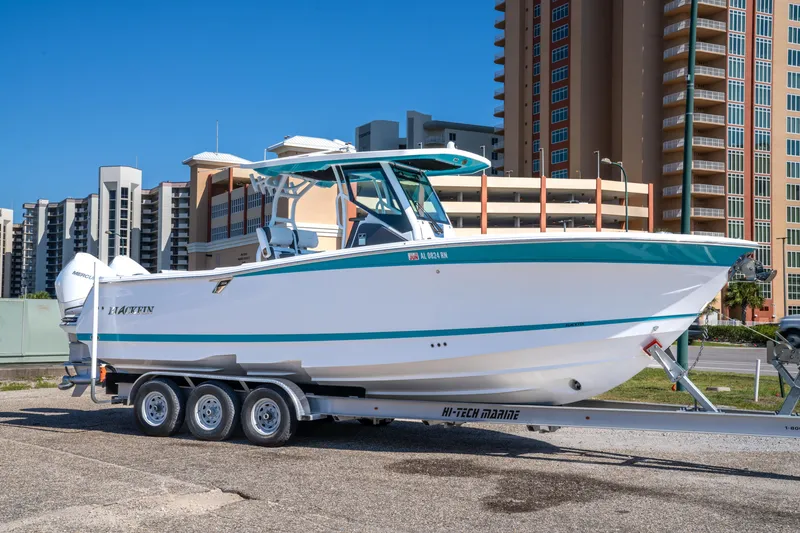 Slide: The Image of 2023 Blackfin 302 CC boat on trailer, urban background, sunny day. - 6