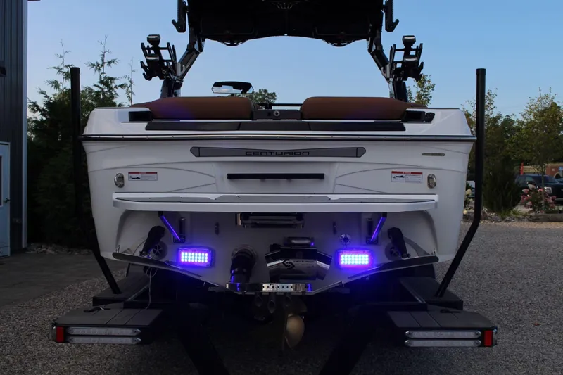 Slide: The Image of 2026 Centurion Ri245 boat rear view with illuminated blue lights. - 10