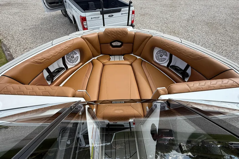 Slide: The Image of 2026 Centurion Ri245 boat interior with tan leather seating and built-in speakers. - 11