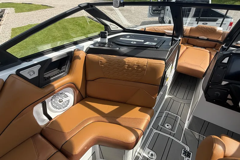 Slide: The Image of 2026 Centurion Ri245 boat interior with tan leather seats and modern dashboard design. - 13