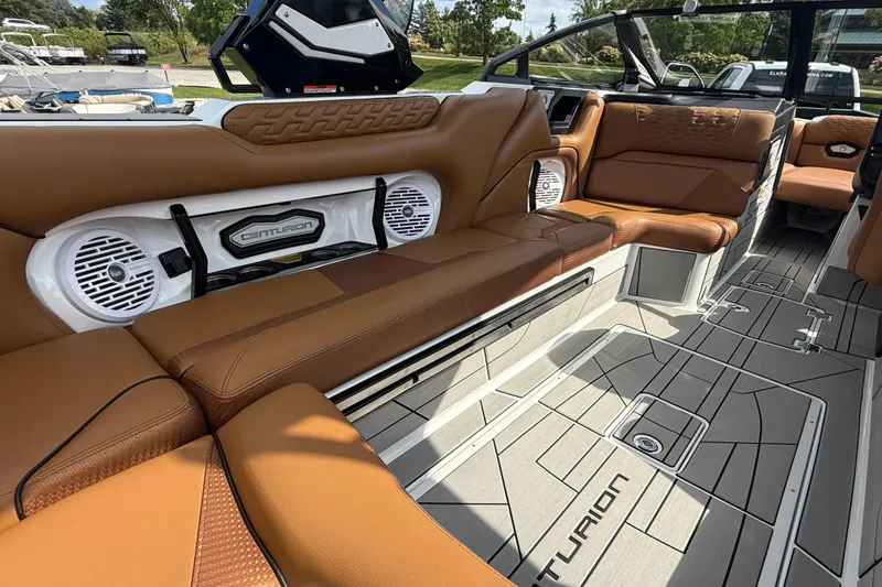 Slide: The Image of 2026 Centurion Ri245 boat interior with brown leather seating and modern audio system. - 16