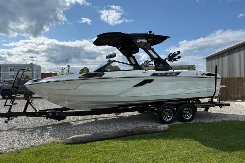 Slide: The Image of 2026 Centurion Ri245 boat on trailer under cloudy sky. - 7