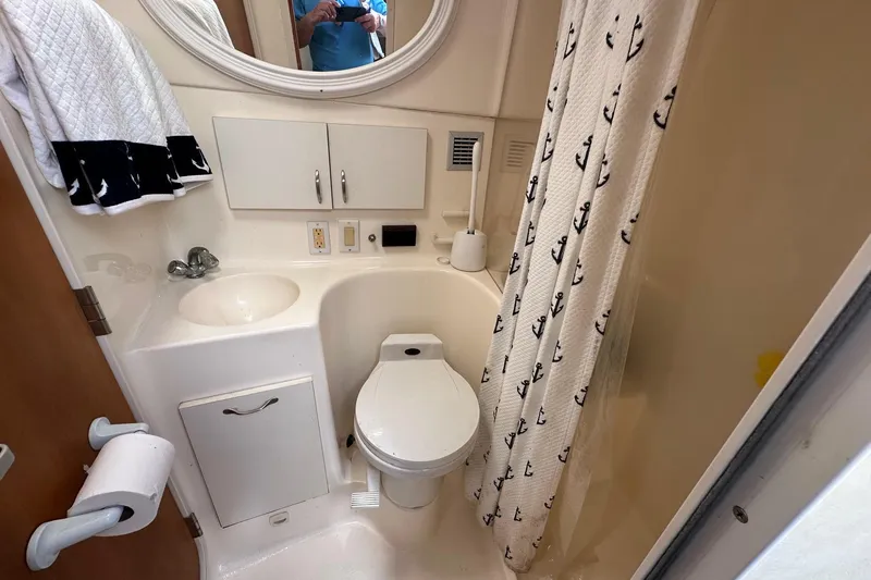 Slide: The Image of Bathroom interior of 1992 Mainship 35 Convertible with nautical-themed shower curtain. - 10