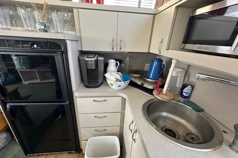 Slide: The Image of Compact kitchen in a 1992 Mainship 35 Convertible boat with appliances and sink. - 11