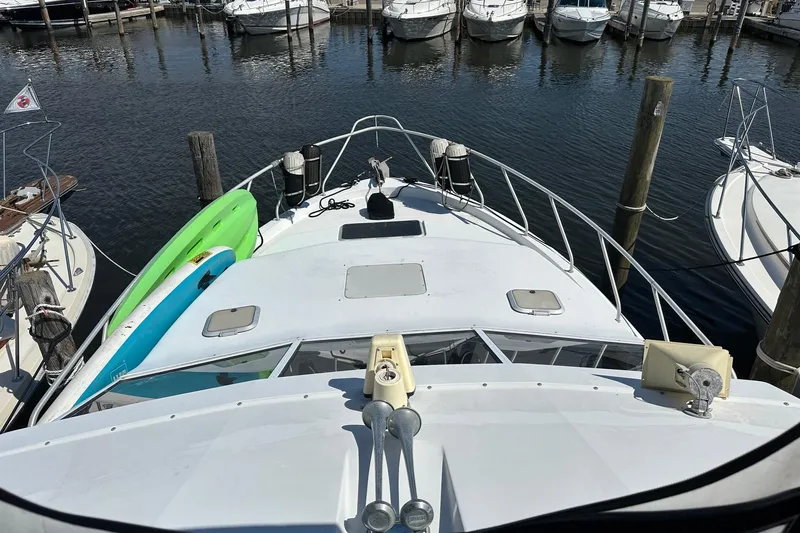 Slide: The Image of 1992 Mainship 35 Convertible yacht docked with paddleboards on deck. - 4
