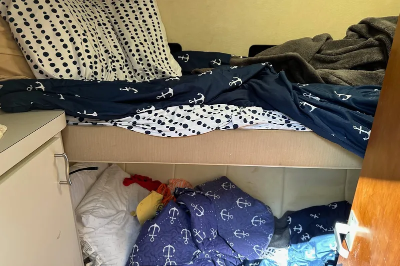 Slide: The Image of Cozy cabin interior of 1992 Mainship 35 Convertible with nautical-themed bedding. - 8
