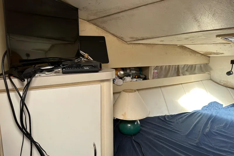 Slide: The Image of Interior of 1992 Mainship 35 Convertible with TV, lamp, and bed. - 9