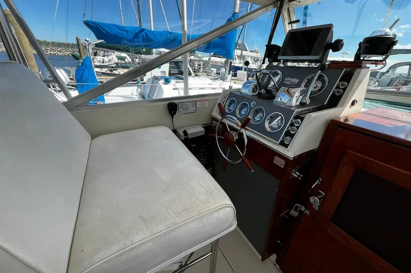 Slide: The Image of 1967 Chris-Craft 31 Commander helm with classic controls and marina view. - 10